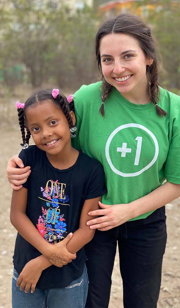 Mission trip participant hugging girl in Dominican Republic