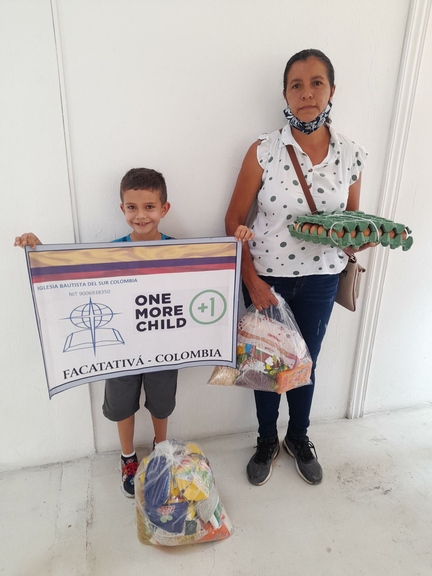 Mother and son receive food through One More Child