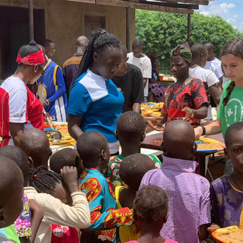 Serving food to Ugandan children