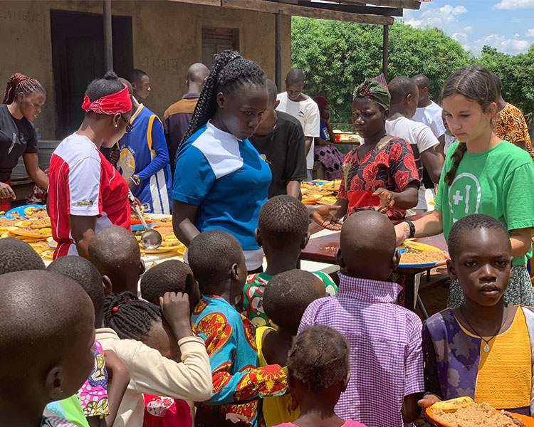 Serving food to Ugandan children