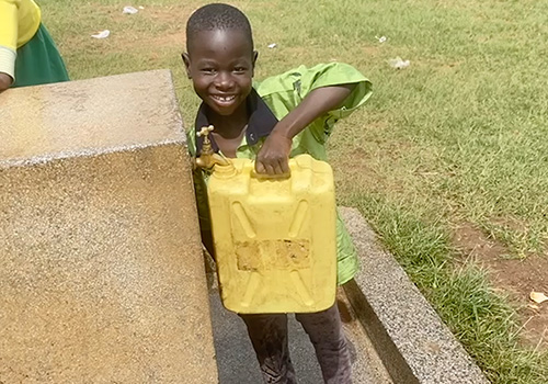 Filling water jugs with clean water from well