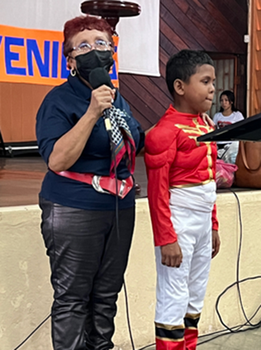 Young boy from Nicaragua speaking at church in power ranger costume
