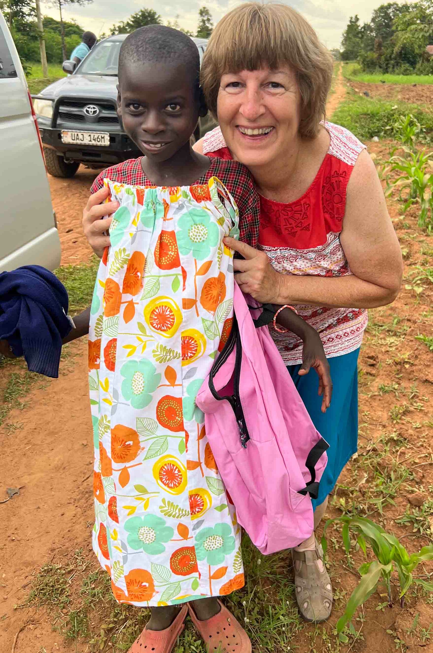 Young girl from Uganda receiving dress