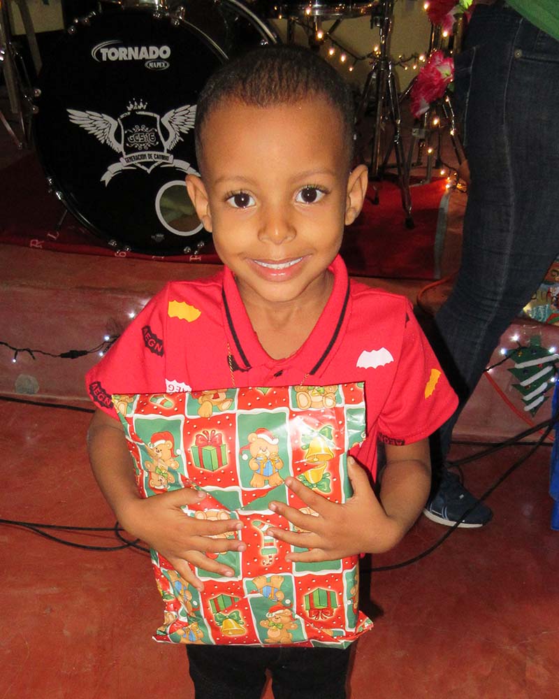 boy in Dominican receives Christmas gift
