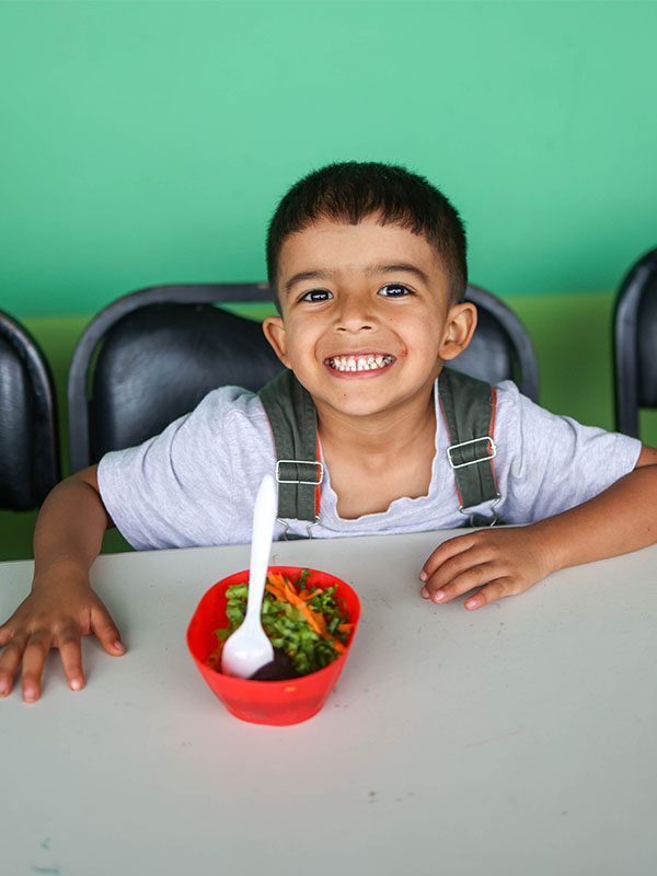 helping a child in Costa Rica with a nutritious meal