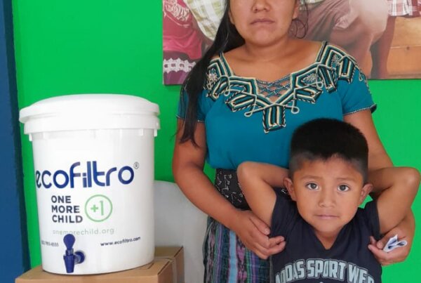 mother and son in Guatemala with water filter from One More Child