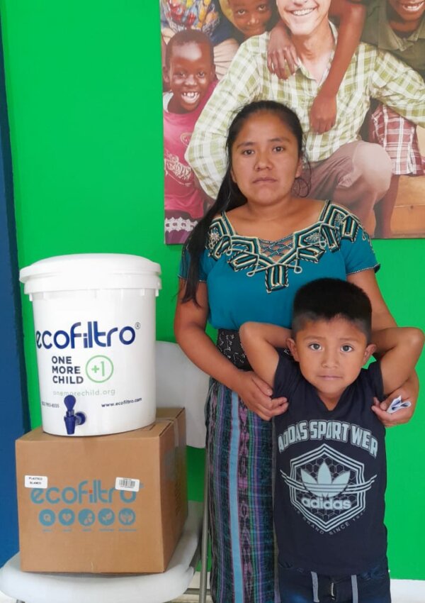 mother and son in Guatemala with water filter from One More Child