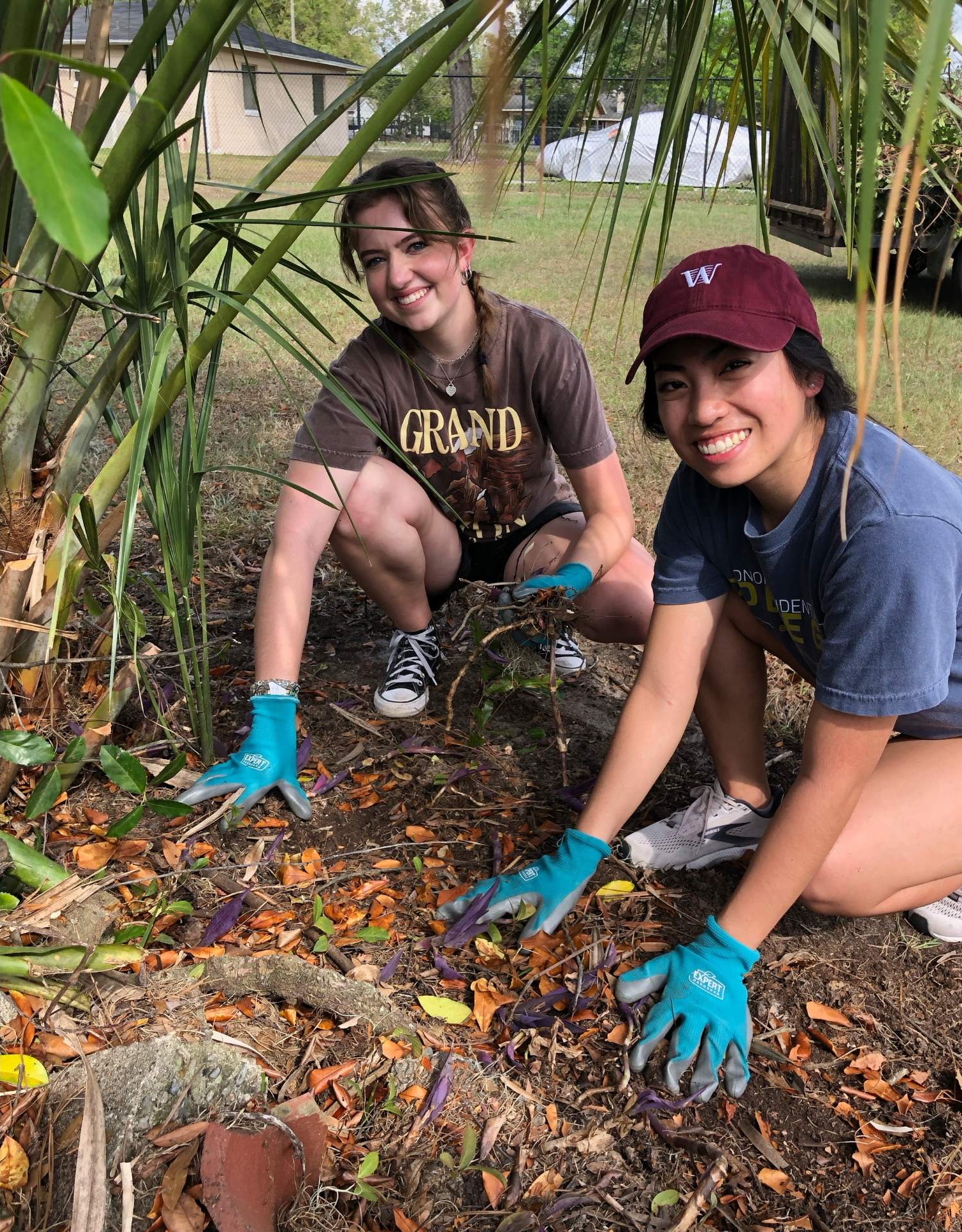 Two girls doing landscaping on a mission trip to Lakeland