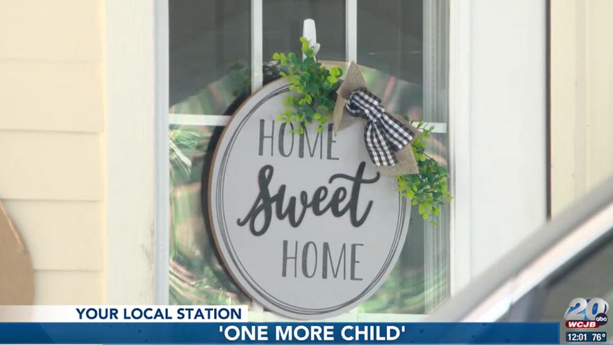 One More Child Foster Care program home "Home Sweet Home" sign.