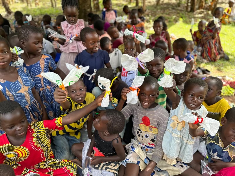 children in uganda show off the butterflies from the one who heals