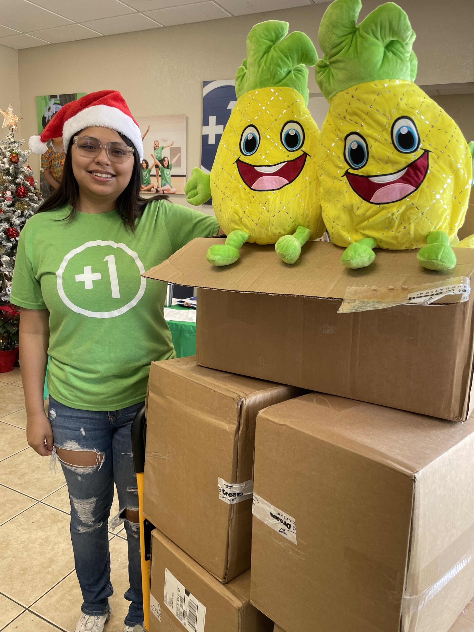 Karen, a One More Child volunteer, unloading pineapple Squishmallows at the Harold Clark Simmons Compassion Center.